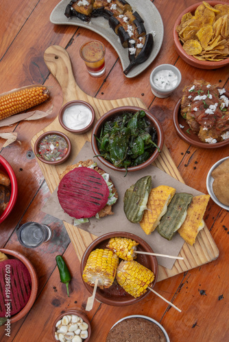 Wallpaper Mural mixed colombian and venezuelan food meal spread on wooden restaurant table Torontodigital.ca