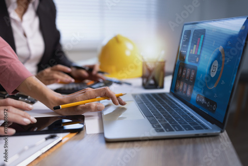 Foto Business people working on construction project with virtual interface of smart building management system