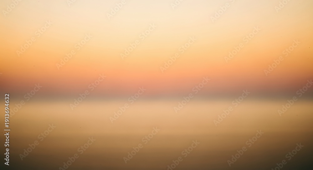 Fototapeta premium Golden sunset over calm water horizon with warm soft light and peaceful reflection