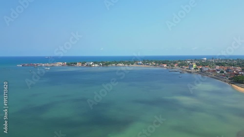 Circular aerial view over Ana Chaves Bay, where you can also see the beautiful coastline of the São Tomé city,Africa.