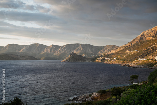 Lush and mountainous landscape and the Aegean Sea seen from Masouri (Massouri) towards north on Kalymnos island in Greece on a sunny afternoon.