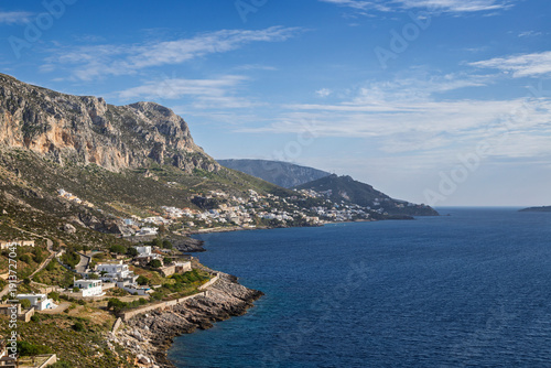 Mountainous and rugged landscape, coastline and the Aegean Sea towards the village of Masouri (Massouri) on Kalymnos island in Greece on a sunny day.