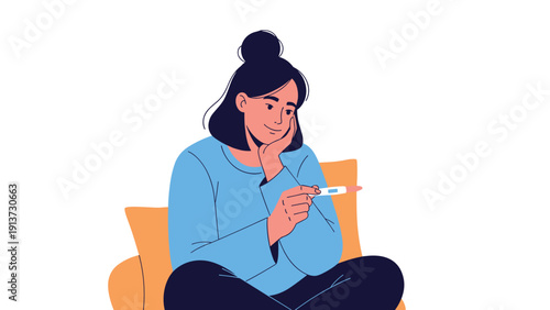 Young woman sitting comfortably on a sofa and looking happily at a positive pregnancy test result in her hands.