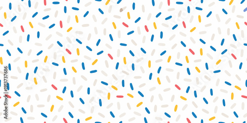 Colorful confetti sprinkles scattered across a bright white background