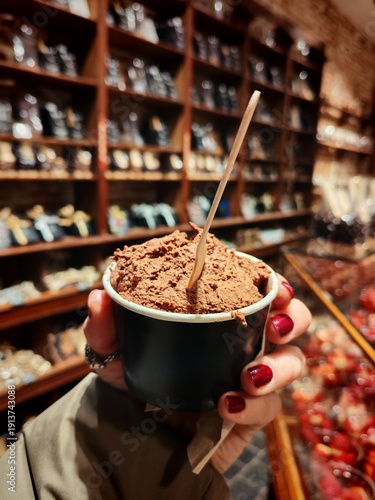 Tableau sur toile Woman holds in her hand chocolate soft and smooth mousse,rich with real belgium