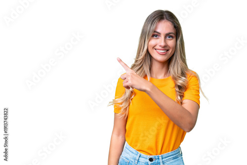 Foto Young Uruguayan woman over isolated background pointing to the side to present a