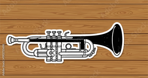 Black and white trumpet sticker on a wood grain background