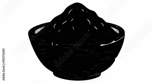 Black bowl filled with dark, granular substance and white flecks