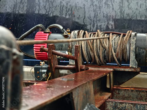 Quadro su tela Rust covered winch with coiled rope under tension on the truck
