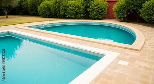 A serene backyard oasis featuring a modern pool with a unique design and lush greenery surroundings.