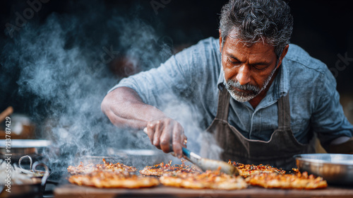 Medium shot of Indian street food vendor cooking at busy stall with steam rising and natural sunlight