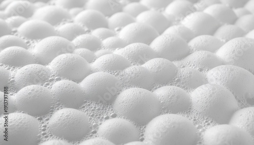 Close-up view of white spherical particles arranged densely on a flat surface