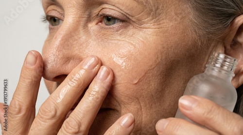 Anti Aging Skincare Routine for Mature Woman Applying Collagen Boosting Serum to Reduce Wrinkles and Improve Skin Elasticity at Home