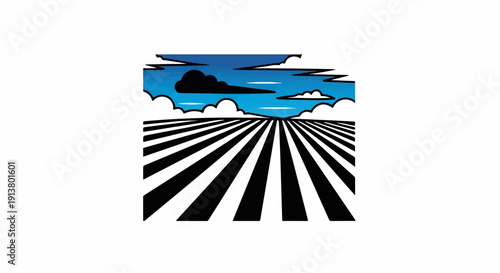 Striped field under a blue sky with clouds