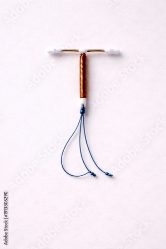 Wallpaper Mural Copper intrauterine contraceptive device with strings isolated on white background. Torontodigital.ca