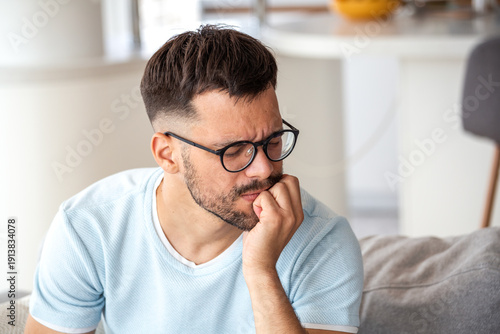 Canvas-taulu Stressed Man Biting Nails and Feeling Anxious at Home, Mental Health Concept