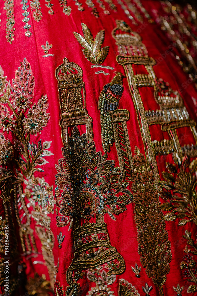 Obraz premium Intricate Embroidered Red Fabric: A Tapestry of Tradition, Craftsmanship, and Vibrant Color for Textiles, Fashion Design, and Cultural Appreciation Art