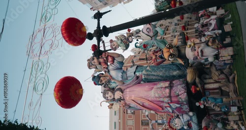 Large Fallas monument displayed in the street during Las Fallas festival in Valencia. Colorful and satirical ephemeral sculpture in a public urban setting.