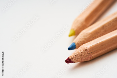 Close-Up of Colored Pencils with Red, Blue, and Yellow Tips on White Background