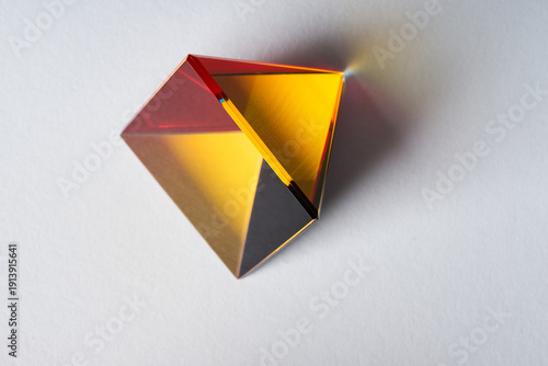 Futuristic Luxury Pyramid Object with Reflective Gold and Red Surfaces