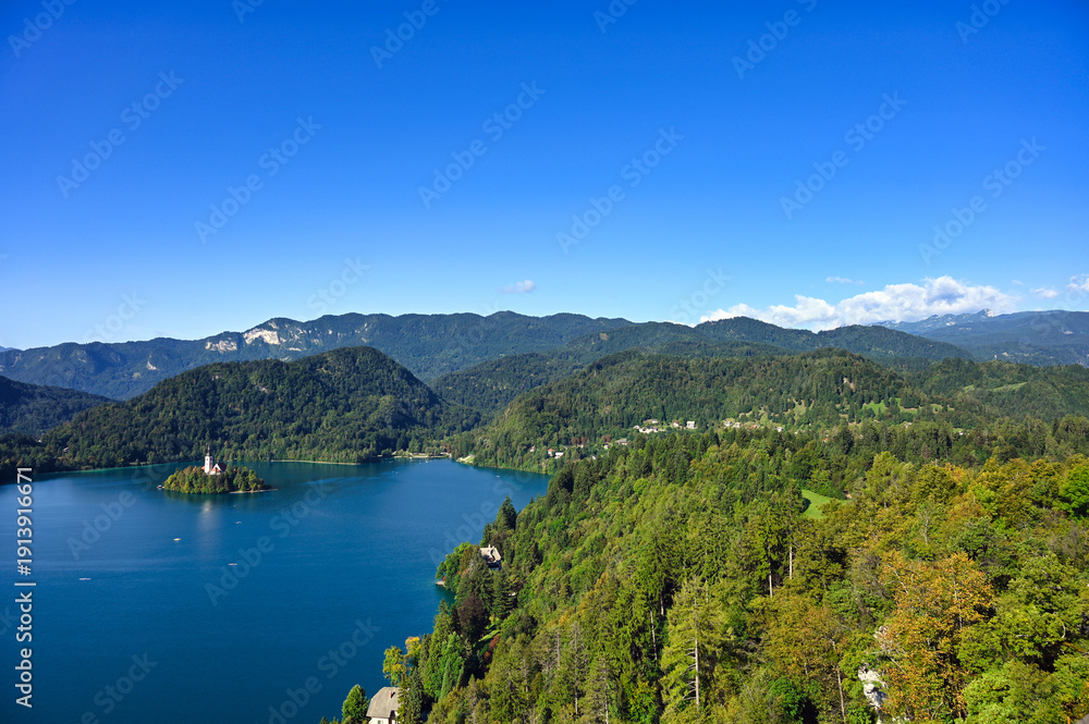 Obraz premium Lake Bled and mountains, summertime landscape,Pilgrimage Church of the Assumption of Maria, Slovenia