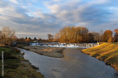 Canvas Print Winter weir at Cvrcovice with ice cascades in warm light