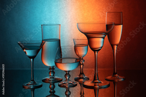 Six glass goblets on a colored gradient background