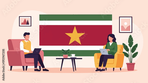 Two people sitting on couches with laptops in front of a national flag