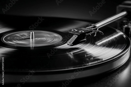 Vinyl record spinning on turntable in a dark room during evening hours with a focus on the needle
