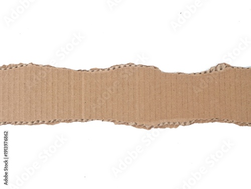 Torn horizontal strip of brown corrugated cardboard isolated on white background. For creative design, recycling concepts, or industrial layouts