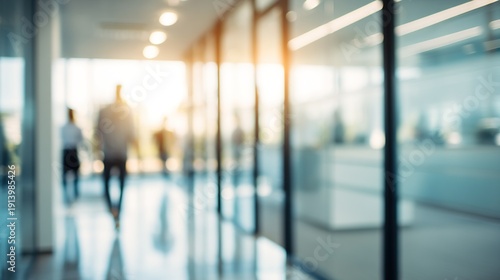 Blurred glass walls in modern office building with blurry people walking through hallway closeup, bright light bokeh effect for corporate life and work concept