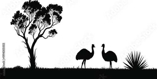 Black silhouette of two emus standing on grass near a tree and spiky plant on white background