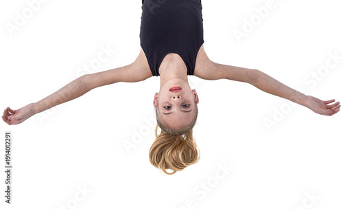 A young athlete lies with her arms outstretched on the white background