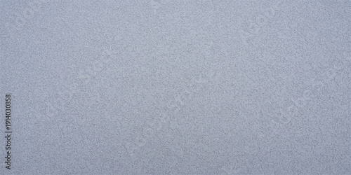 Abstract textured surface in a soft, dusty blue-gray hue, with a subtle, mottled pattern resembling fine speckles or a coarse fabric.