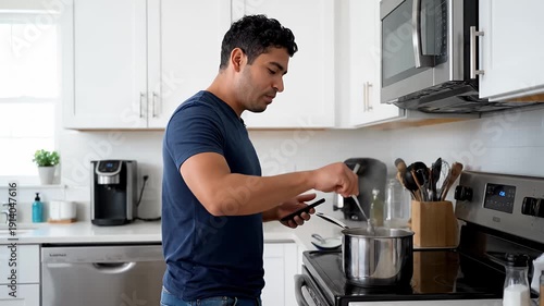 Man cooking in a modern kitchen, pouring water into a pot on the stove