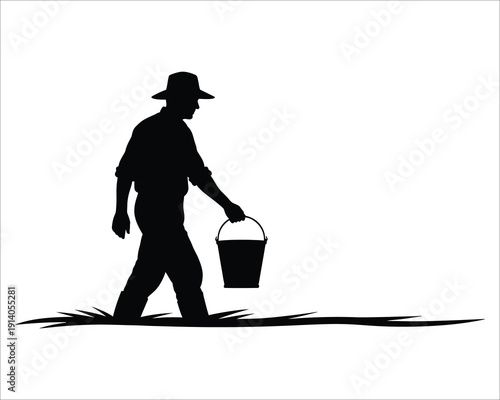 Silhouette of a man walking with a bucket
