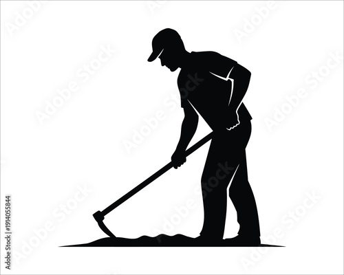 Silhouette of a man digging with a shovel