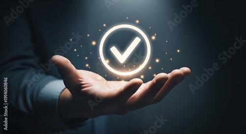 Businessman hand holding glowing checkmark symbol for quality assurance, service guarantee, and standard compliance