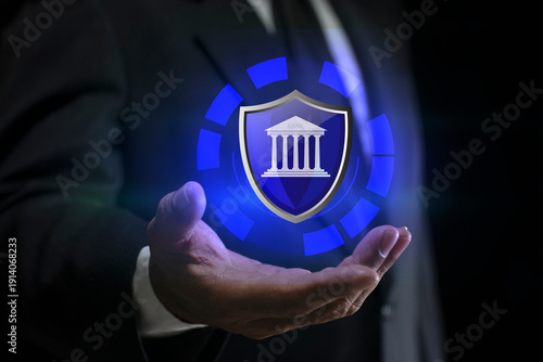 Businessman holding Abstract glowing shield with bank icon. Digital Banking system with secure financial institution shield and global data network.