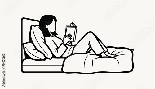 A woman is reading a book while lying on a bed