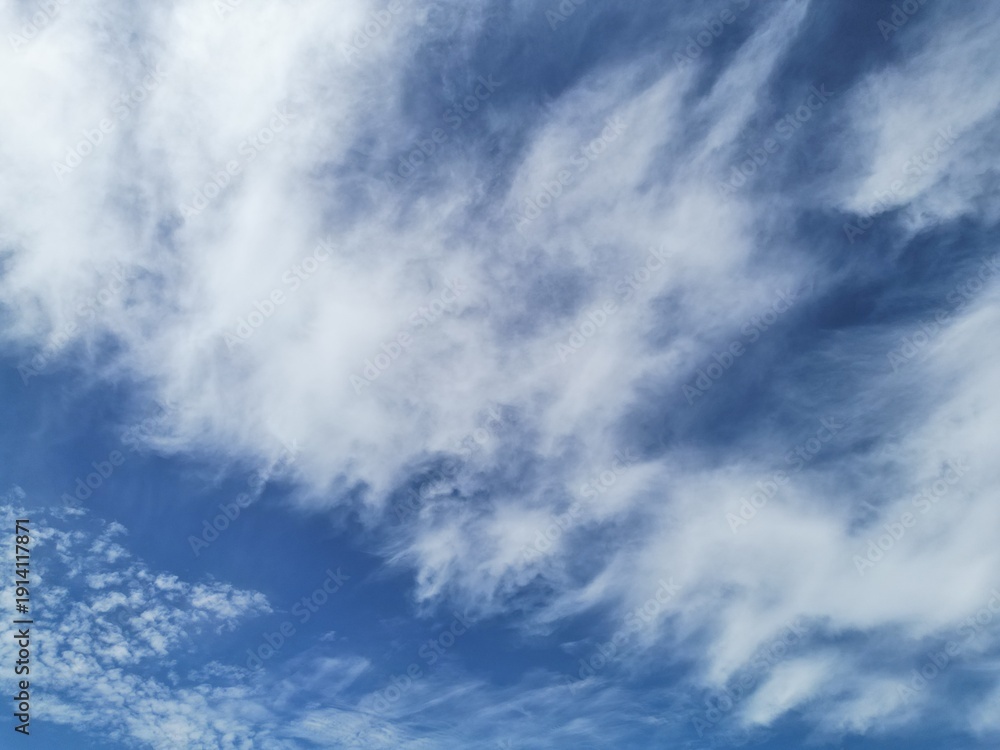 Fototapeta premium Blue Sky and White Clouds Over Mountains and Forest