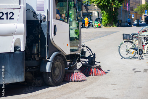 Fotografija Municipal street sweeper cleaning road, urban sanitation service in European city