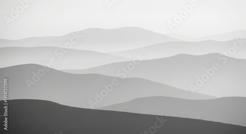 Misty mountain range landscape with layered fog and serene atmosphere minimalist nature scene