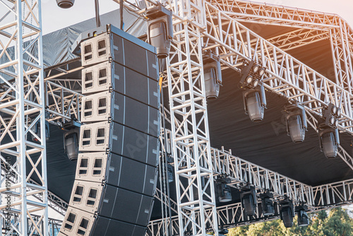 Canvas Print Professional audio line array speakers and moving head light fixtures hanging on