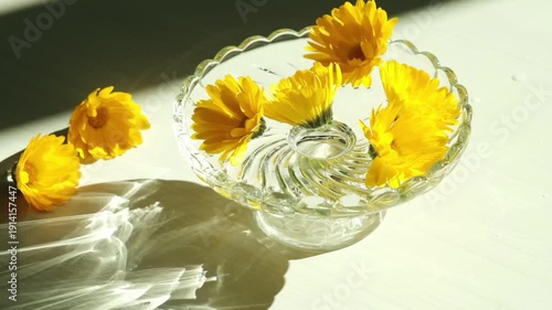yellow flower in a glass