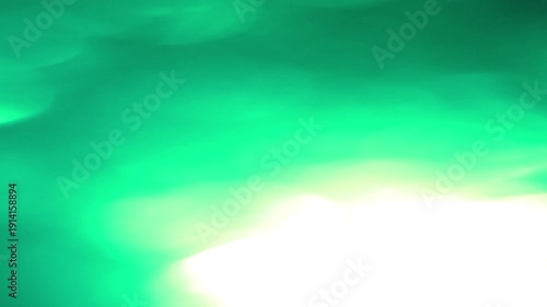 Dynamic Light Leak Bokeh Transition with vibrant green hues and soft focus effects. Perfect for adding a magical glow.