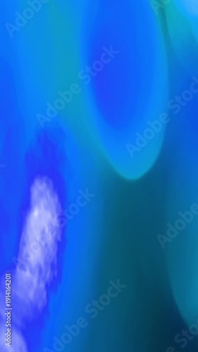 Dynamic Vertical Light Leak Bokeh Transition with vibrant blue and green hues, perfect for creative projects.