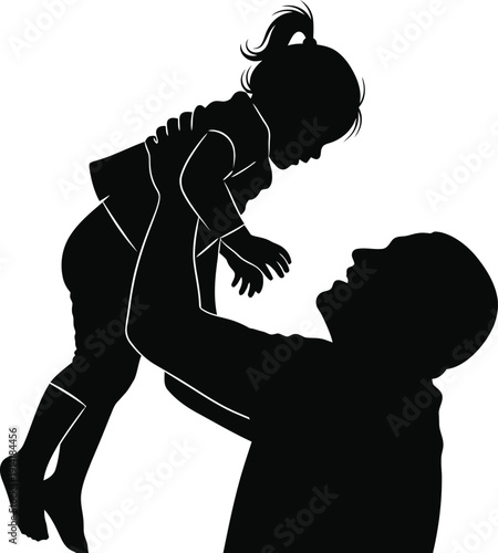 Silhouette of a man lifting a little girl in the air playfully outdoors