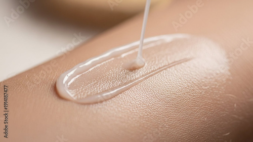 Close-up of transparent gel being applied to human skin for skincare treatment.