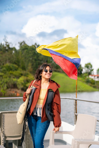 Fotografie Young happy smiling Latina woman enjoys a peaceful boat tour on the lake once ho